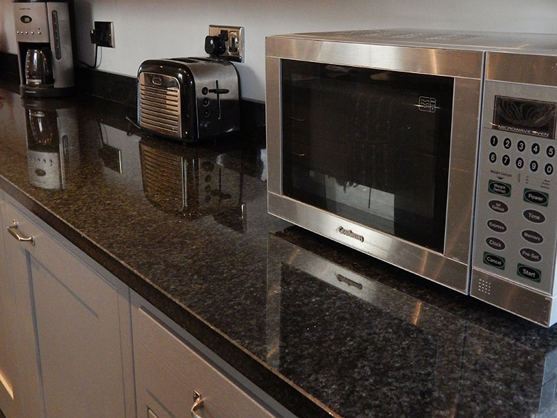 Pearl black granite worktops fitted to complement grey shaker-style units