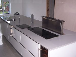 White Mirror quartz island with integrated extractor fan and plug socket, templated, manufactured and fitted by Millstone Designs