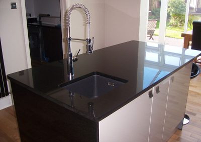 Kitchen island in Star Galaxy granite with an under mounted sink, templated, manufactured and fitted by Millstone Designs